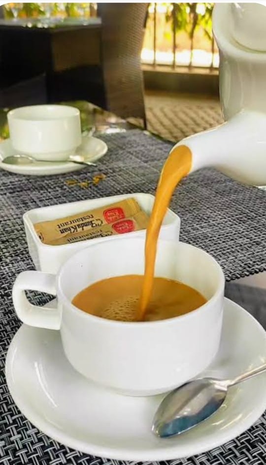Karak chai being poured into a cup