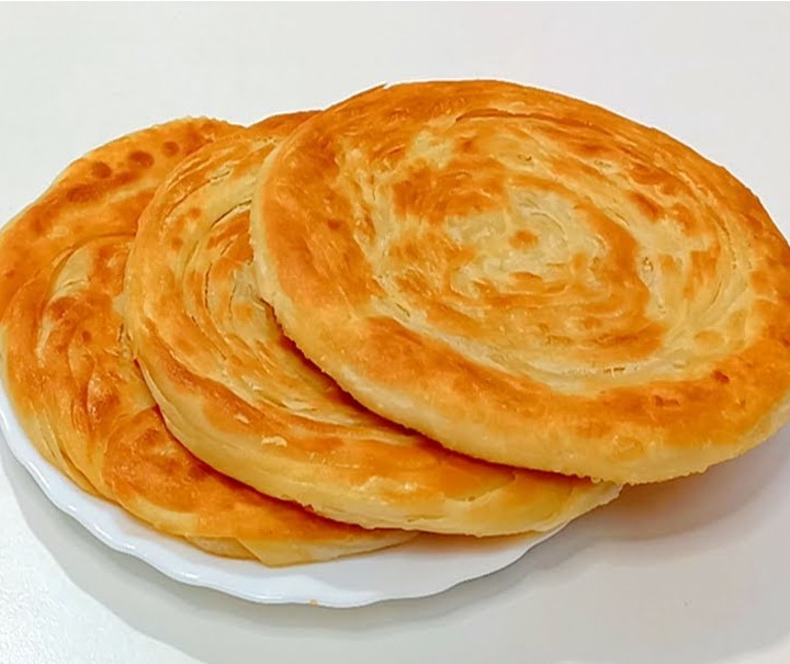 Crispy layered lachha parathas fresh off the tawa